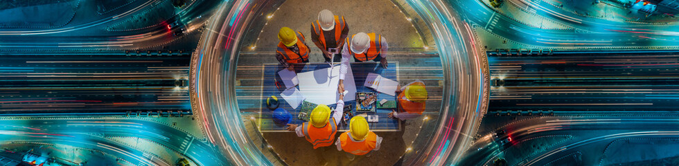 Holding hands top view of Architectural engineers working on solar panel and his blueprints with...