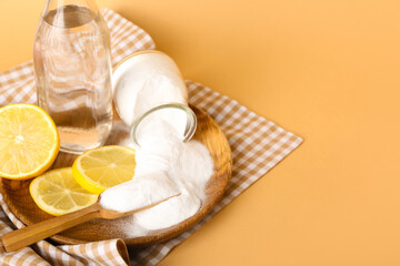 Plate with baking soda, slices of lemon and bottle of water on color background, closeup