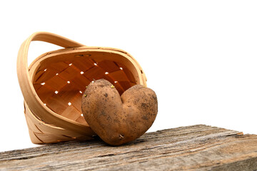 Heart shaped potato against a woven basket