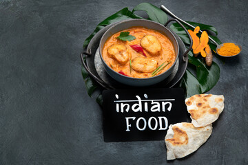 Kerala fish curry on dark background.