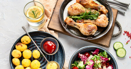 Baked chicken legs with salad and potatoes