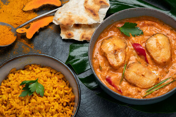 Kerala fish curry on dark background.