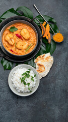 Kerala fish curry on dark background.