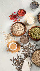 Variety of edible seeds on light background.