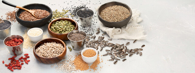 Variety of edible seeds on light background.