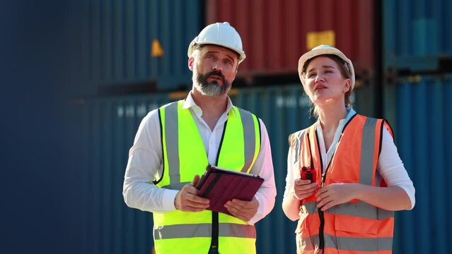 Slow motion VDO. Customs man and women dock manager control loading Containers box from Cargo at container yard. Import and Export concept. Marine, carrier and logistic insurance