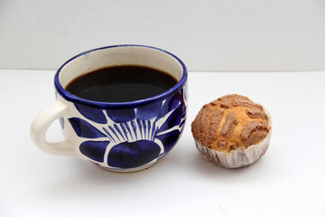 Fresh, delicious and fluffy Mexican bread Manteconchas cupake type vanilla and chocolate flavor accompanied by coffee on a white background traditional of the culture of Mexico

