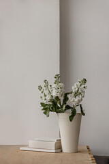 White mattiola in a vase on the window. Place for text