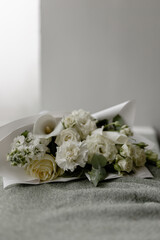 Spring delicate bouquet of flowers in white shades. Alstroemeria, calla, rose, dianthus, matthiola.