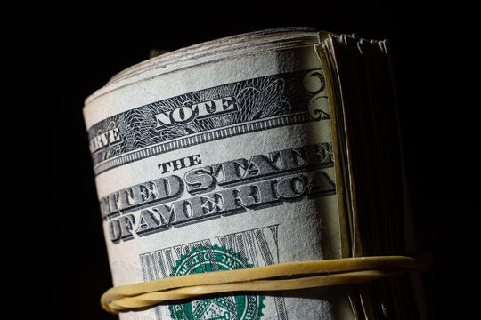 twisted stack of twenty-dollar American dollar banknotes