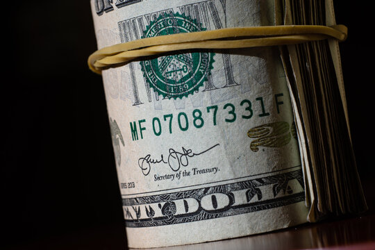twisted stack of twenty-dollar American dollar banknotes