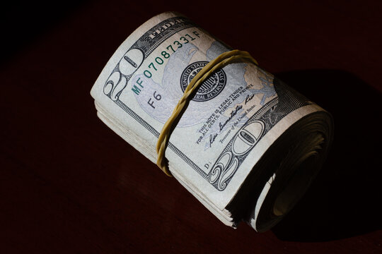 twisted stack of twenty-dollar American dollar banknotes