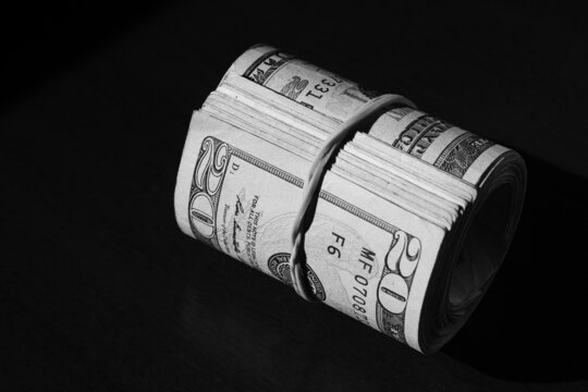 twisted stack of twenty-dollar American dollar banknotes