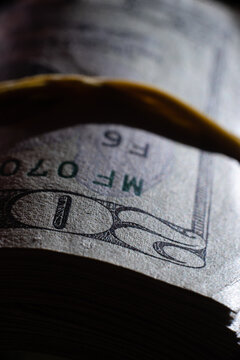 twisted stack of twenty-dollar American dollar banknotes, closeup