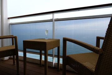 Balcony verandah of luxury cruiseship cruise ship liner stateroom cabin suite with rattan seats and...