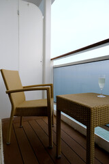 Balcony verandah of luxury cruiseship cruise ship liner stateroom cabin suite with rattan seats and...