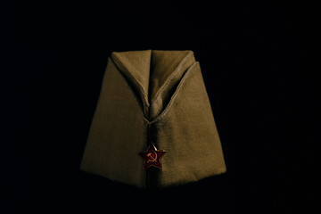 Cap with red star, headdress serviceman red army Soviet Union, on black background.