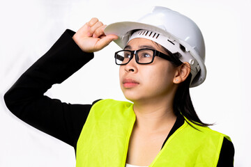 Confident female engineer wearing a helmet and looking into the distance isolated on white background in studio.