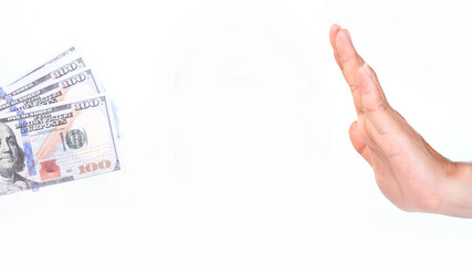 Female hand giving money and hand making refusal gesture on white background.