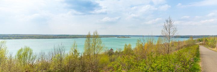 Scenic bike path down to the Markkleeberger lake near Leipzig in early spring