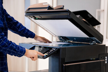 Businessmen press button on the panel for using photocopier or printer for printout and scanning...
