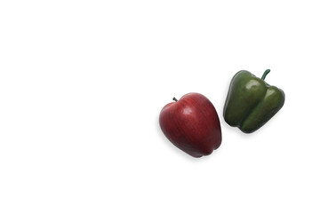 Green organic bell pepper and apple isolated on white background.