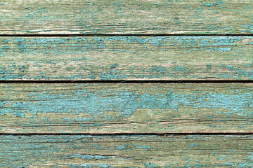 Vintage wooden background with peeling blue paint. Texture of old blue wood with natural patterns.