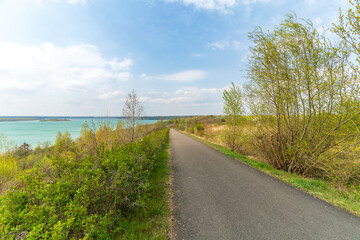 Scenic bike path down to the Markkleeberger lake near Leipzig in early spring
