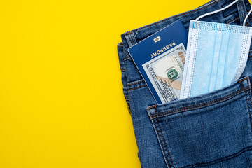 Pocket with jeans passport money and protective mask. Pandemic travel concept.