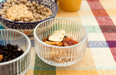 Dried fruits in a glass plate on the table. Close-up. Selective focus.