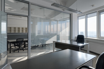 modern office with glass partitions, office space with tables and chairs