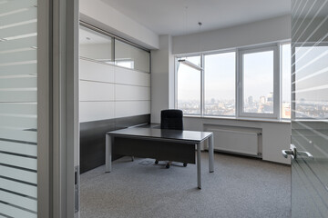 modern office with panoramic windows and city views, office space with table and chair