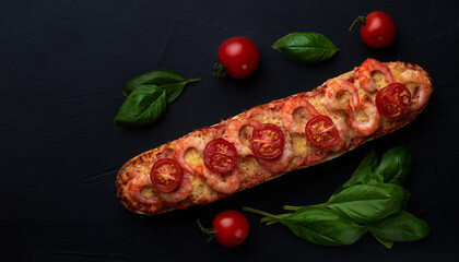 Homemade baguette sandwich or pizza with shrimp, cherry tomatoes on top. Top view photo on a dark background with place for your text.