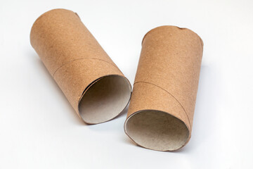 Two brown empty toilet paper rolls on a white background. Toilet paper roll sleeves on a white background