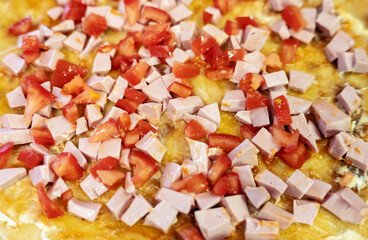 Homemade pizza with tomatoes, cheese and sausage.