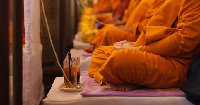 Monks are chanting a Buddhist ritual. Pray and meditation in temple, Thailand
