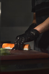 Sushi Chef Slices fresh Salmon on the sushi bar, Chef cutting sushi at professional kitchen,...