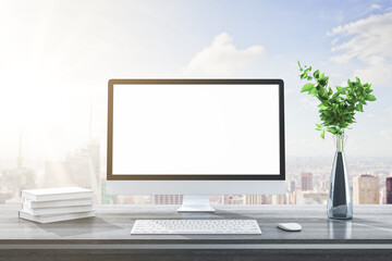 Close up of modern designer desktop with books, empty white computer screen, decorative plant, supplies and city and sky view background. Mock up, 3D Rendering.