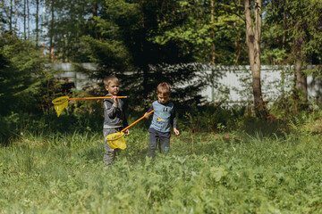little boys with butterfly nets in countryside. Image with selective focus
