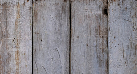 Old wooden planks with distressed hammer dents and markings background texture