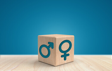 Male and female gender icons or symbols on two sides of a wooden cube. Gender equality concept.