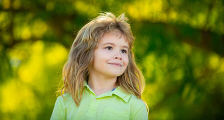 Portrait of a cute little boy in spring park. Happy kid having fun outdoors.