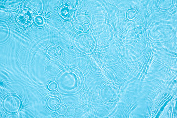 Transparent blue clear water surface texture with ripples, splashes and bubbles. Abstract nature background Water waves in sunlight. Cosmetic moisturizer micellar toner emulsion. Top view, copy space