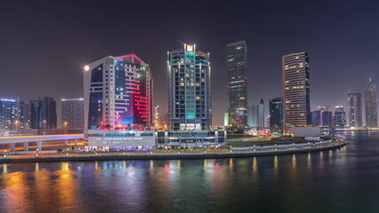 Fototapeta na wymiar Modern city architecture in Business bay district. Panoramic view of Dubai's skyscrapers night timelapse