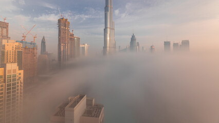 Aerial view of Dubai city early morning during fog timelapse.