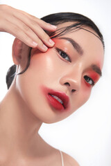 Closeup photo of Beauty Asia girl with a great skin texture with impressive Asia vibes makeup in the white background