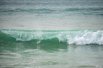 Summer beach, ocean waves on a tropical sea with deep blue wawes. Calm sea, ocean background.