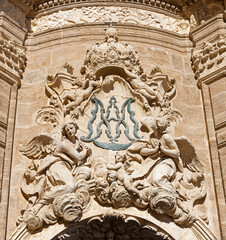 Valencia - The detail of baroque portal of Cathedral - Basilica of the Assumption of Our Lady of Valencia with the marianic initials designed by architect Antoni Gilabert Fornes from 18. cent.
