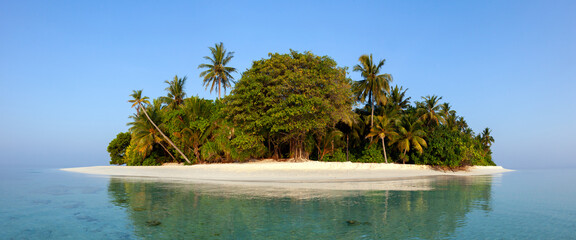 Little island in Maldives at morning light