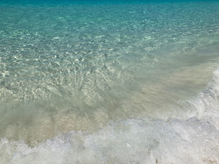big splash sea waving on white sand beach with crystal clear Andaman blue sea in daylight